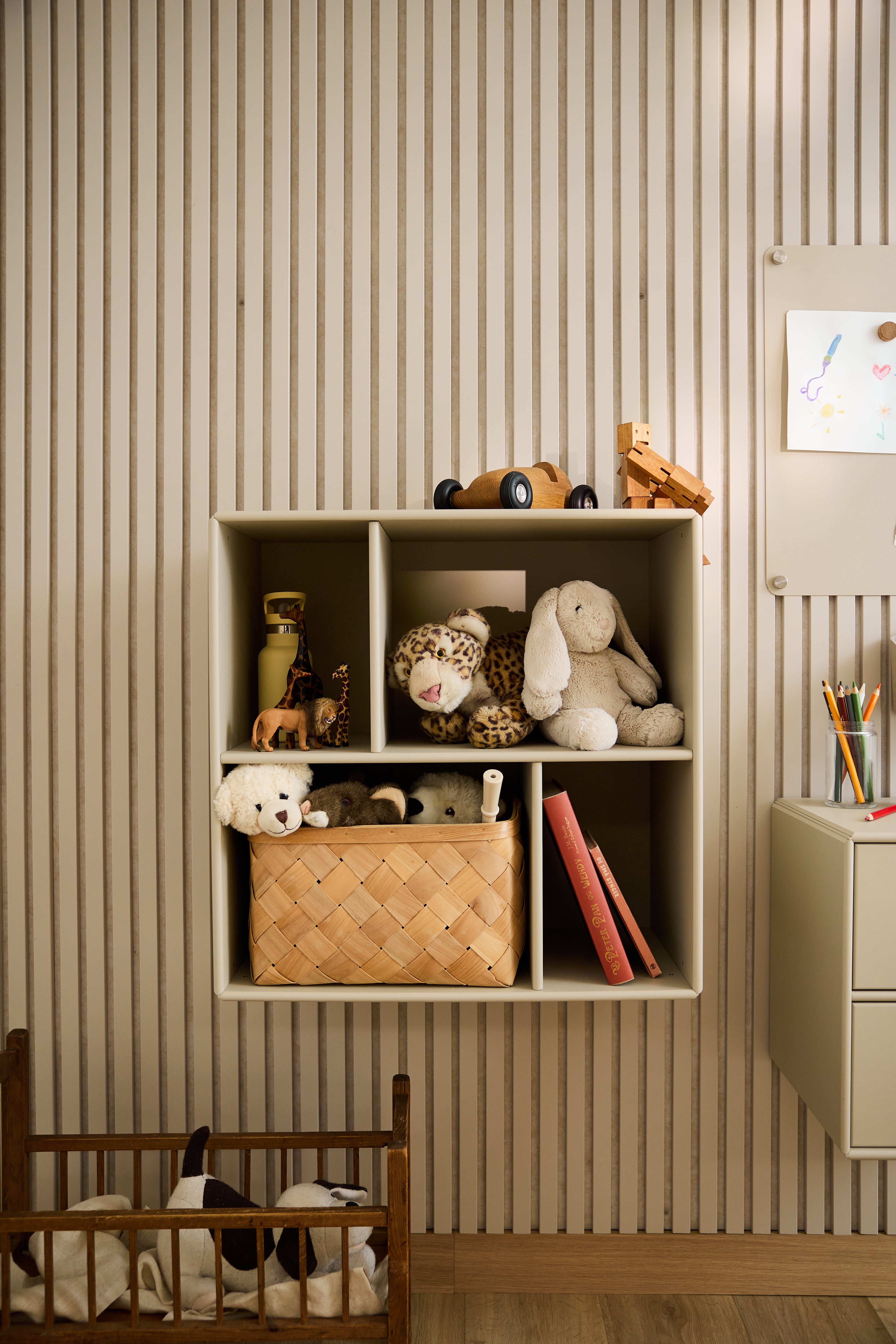 WoodUpp Arka Open Cabinet in beige with toys and books, set against striped wallpaper in a child’s room, showcases minimalist Nordic design.
